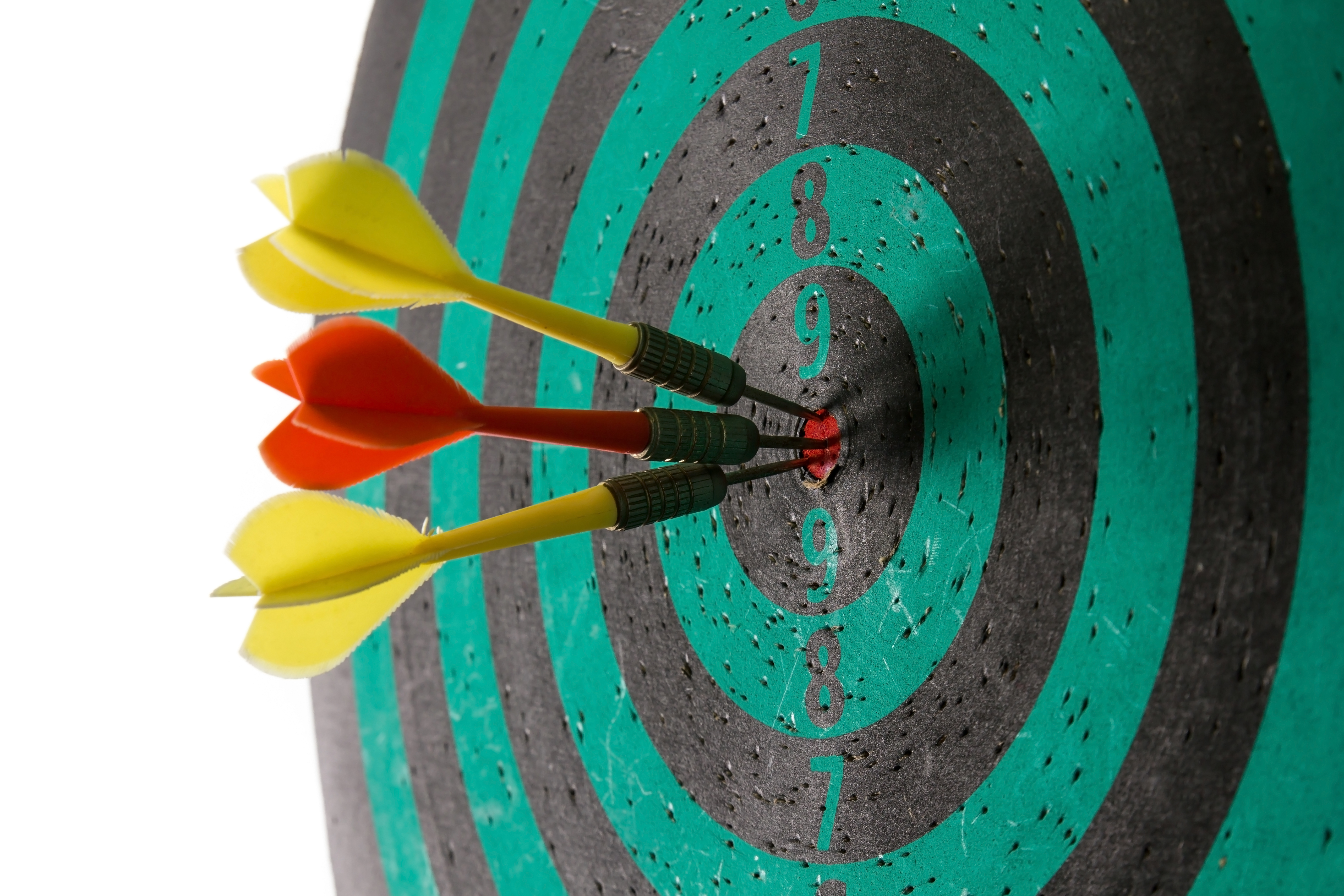 Three darts in a bulls-eye representing achieving your goals