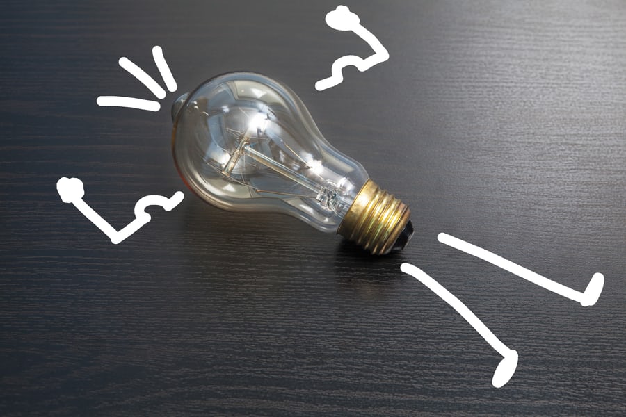 Lightbulb depicted with drawn idea and limbs 