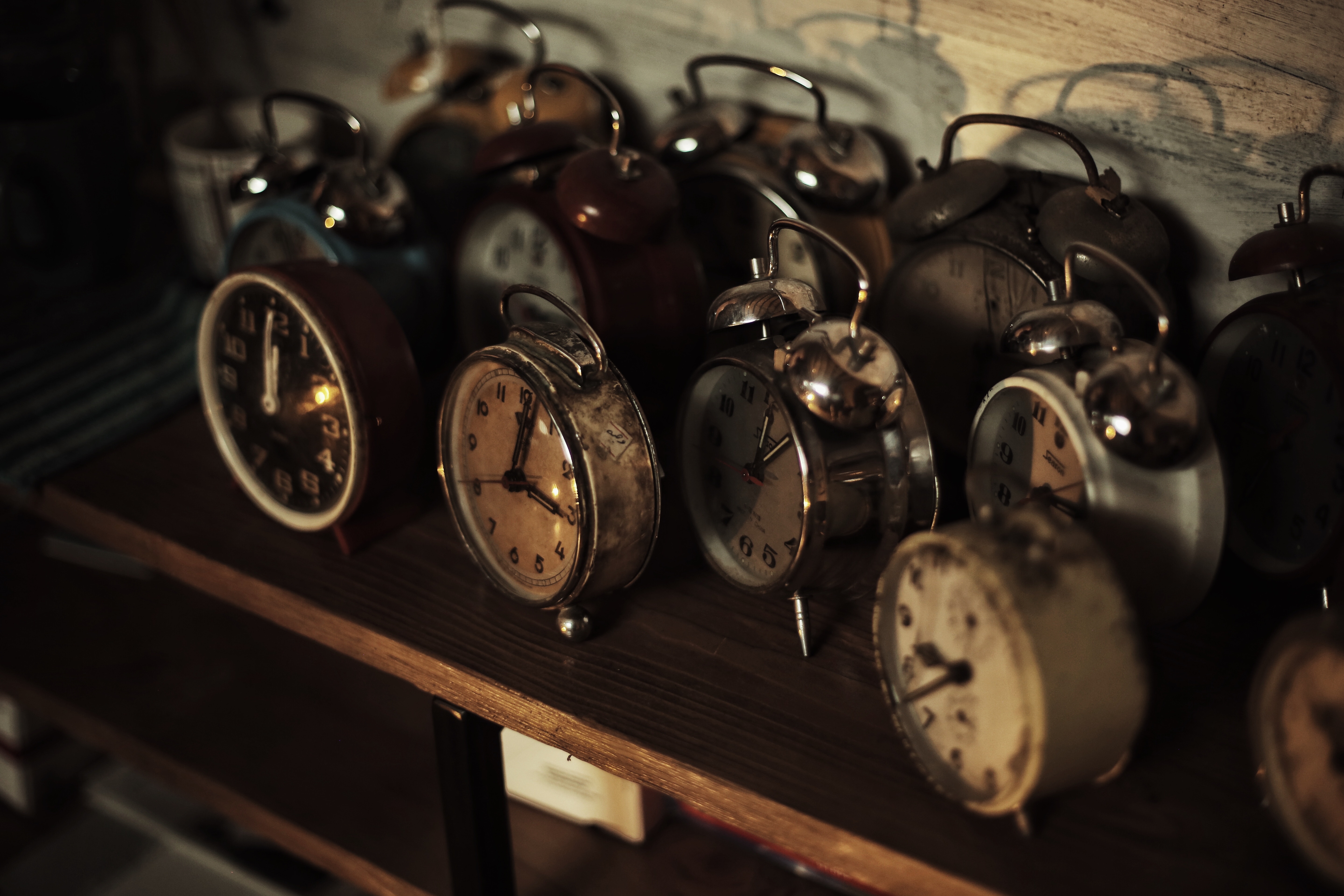 A row of old-fashioned alarm clocks showing how it's hard to break what you're used to 