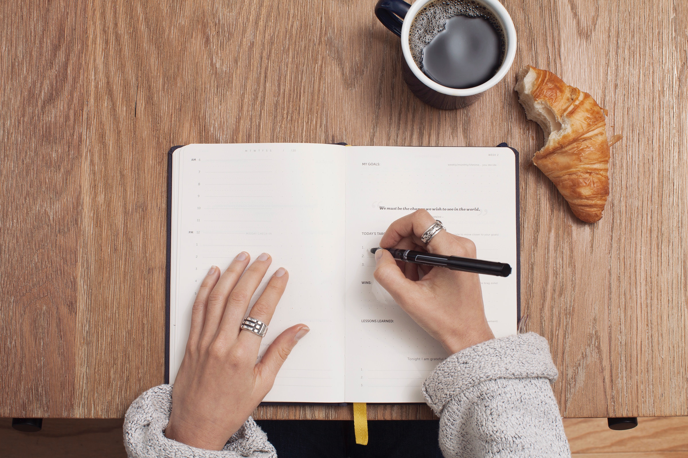 A woman creating a good habit by writing down her goals 