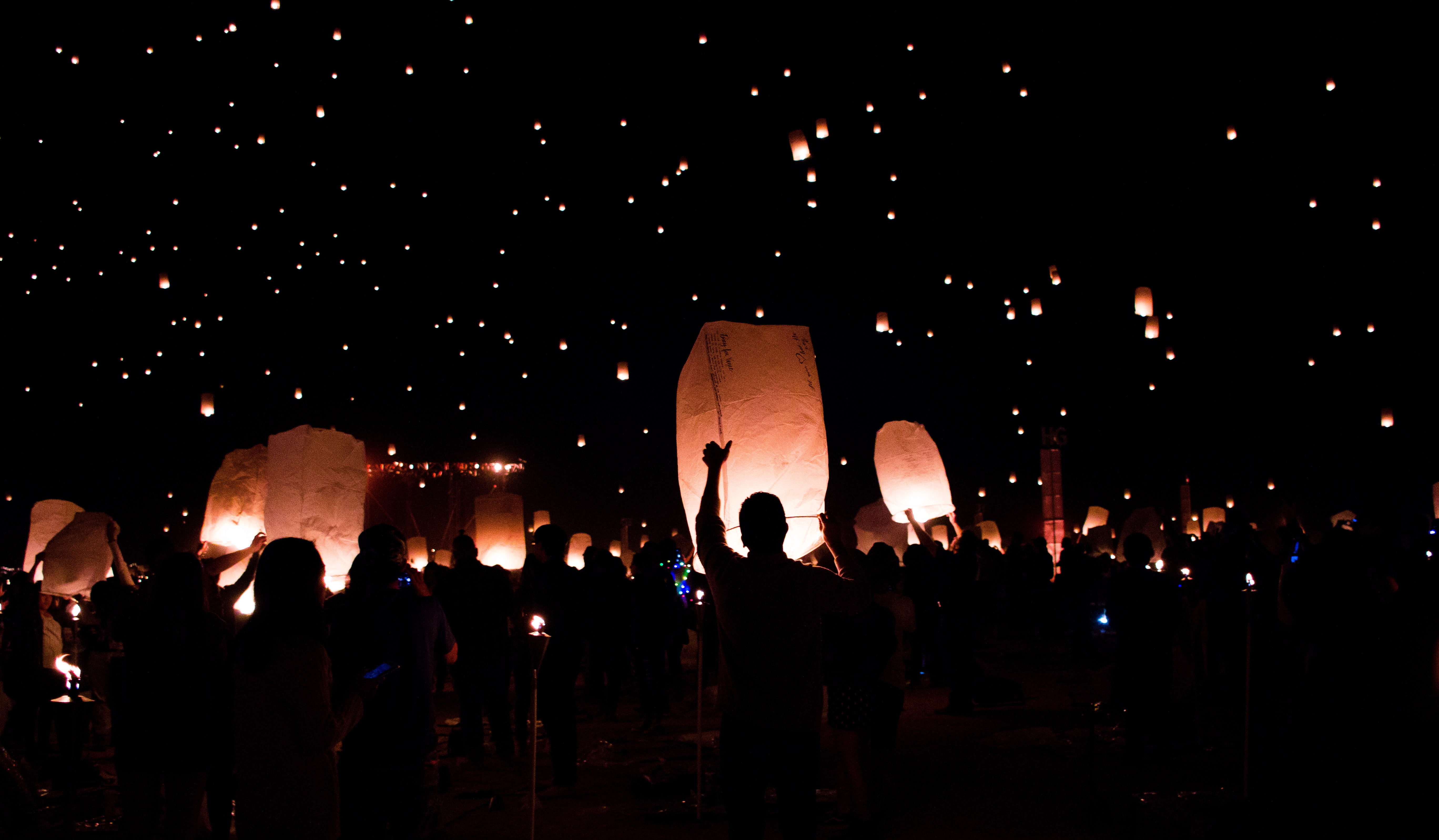 A group of people letting go of their sky lanterns 
